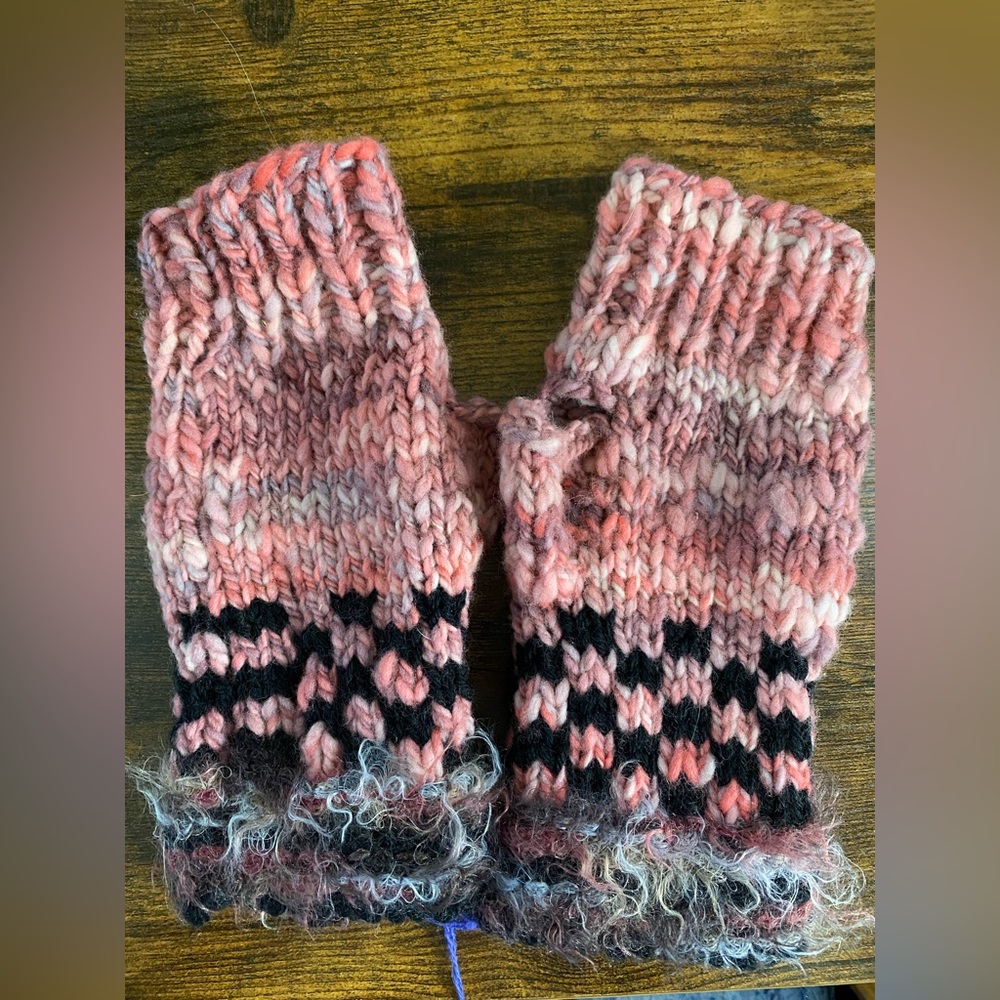 Handmade fingerless gloves in pinks, black and gray.